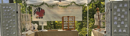 The Pearled Squirrel 2026 show booth with jewelry stands and tables