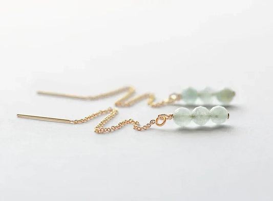 Aquamarine bead threader earrings with gold chain on a white background