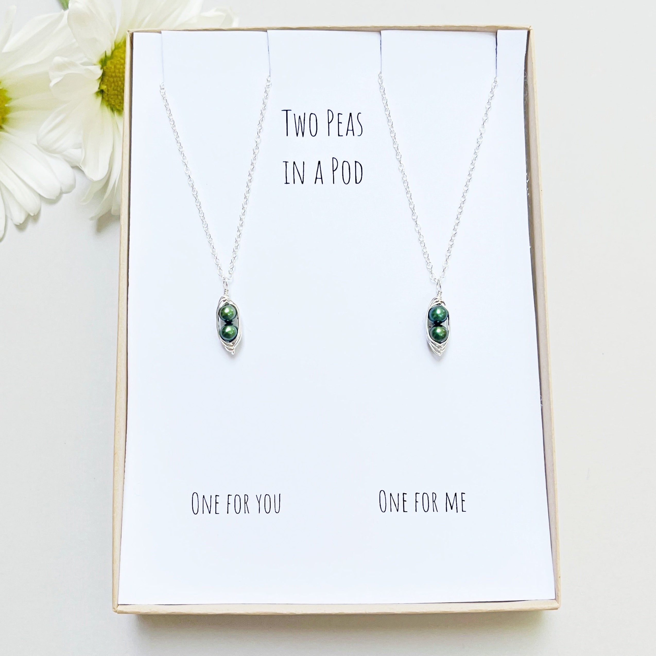 Two peas in a pod pearl necklace set in a box.